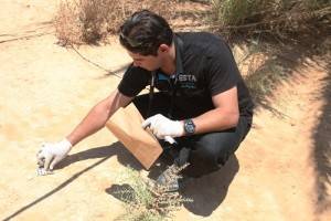 An Iraqi police officer gathers evidence during a crime scene exploitation training exercise held at Asad Air Base, Iraq, July 6, 2011. The U.S. Army?s 2nd Advise and Assist Brigade, 82nd Airborne Division, conducted the training. (U.S. Army photo by Pfc. Brian Chaney/Released)